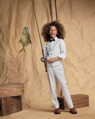 Child holding a fishing rod while wearing Linen Oceanside Plaid Stretchy Mod Suit Pant and bow tie.