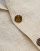 Close-up of the fabric and buttons of the Linen Ivory Sports Jacket.