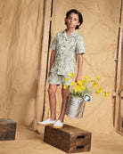 Linen Sage Sunflower Camp Collar Shirt worn by a child, featuring a relaxed collar and floral print, paired with matching shorts.