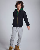 Child wearing Novelty Grey Heather Sideline Sweatpants with a black jacket and stylish boots.