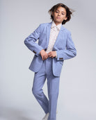 Young model wearing Pacific Blue Stretchy Mod Suit, styled with a printed shirt and stylish pose.
