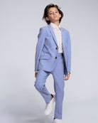 Pacific Blue Stretchy Mod Suit Pant worn by a young boy, styled with a white shirt and sneakers, showcasing a smart look.