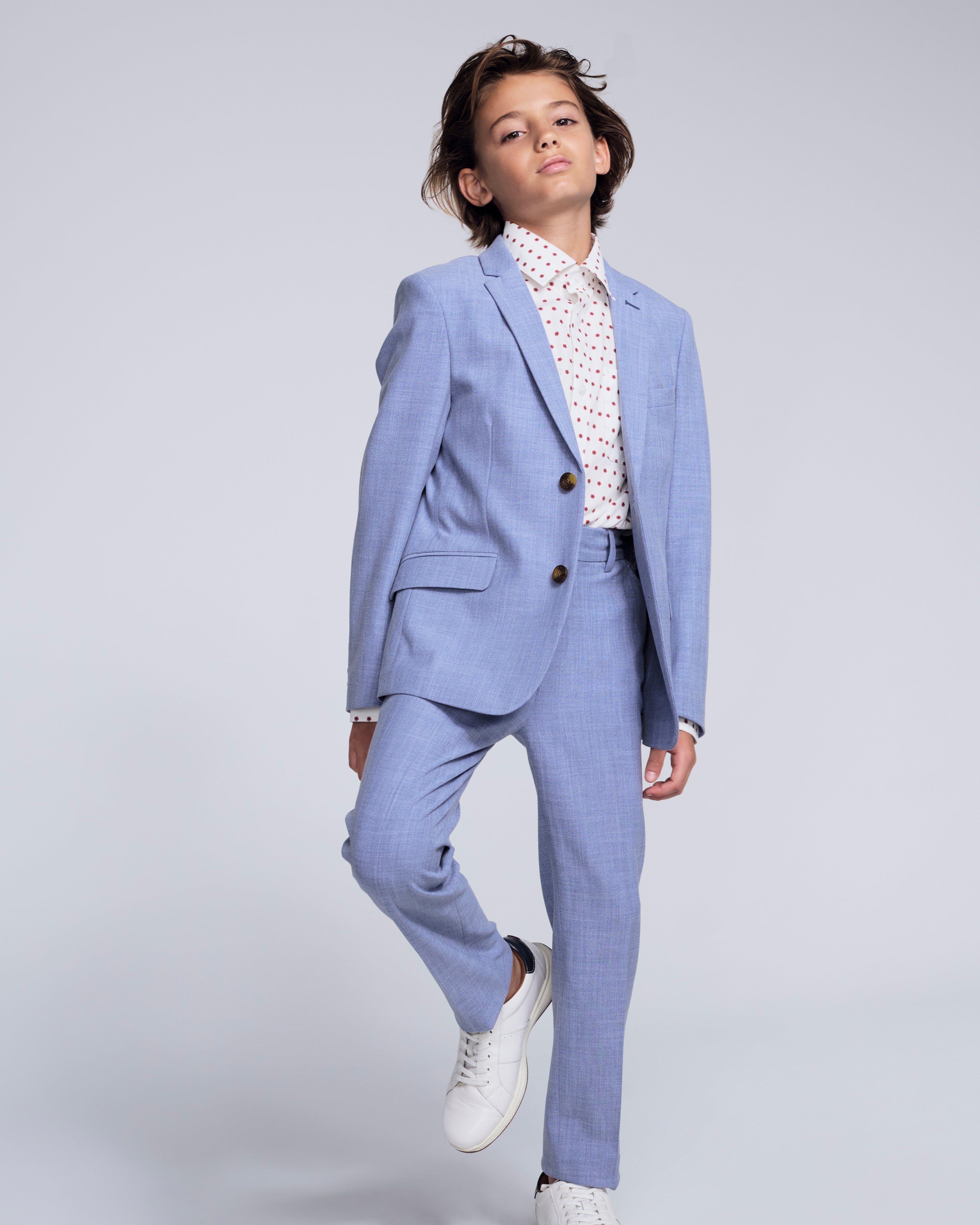 Pacific Blue Stretchy Mod Suit Pant worn by a young boy, styled with a white shirt and sneakers, showcasing a smart look.
