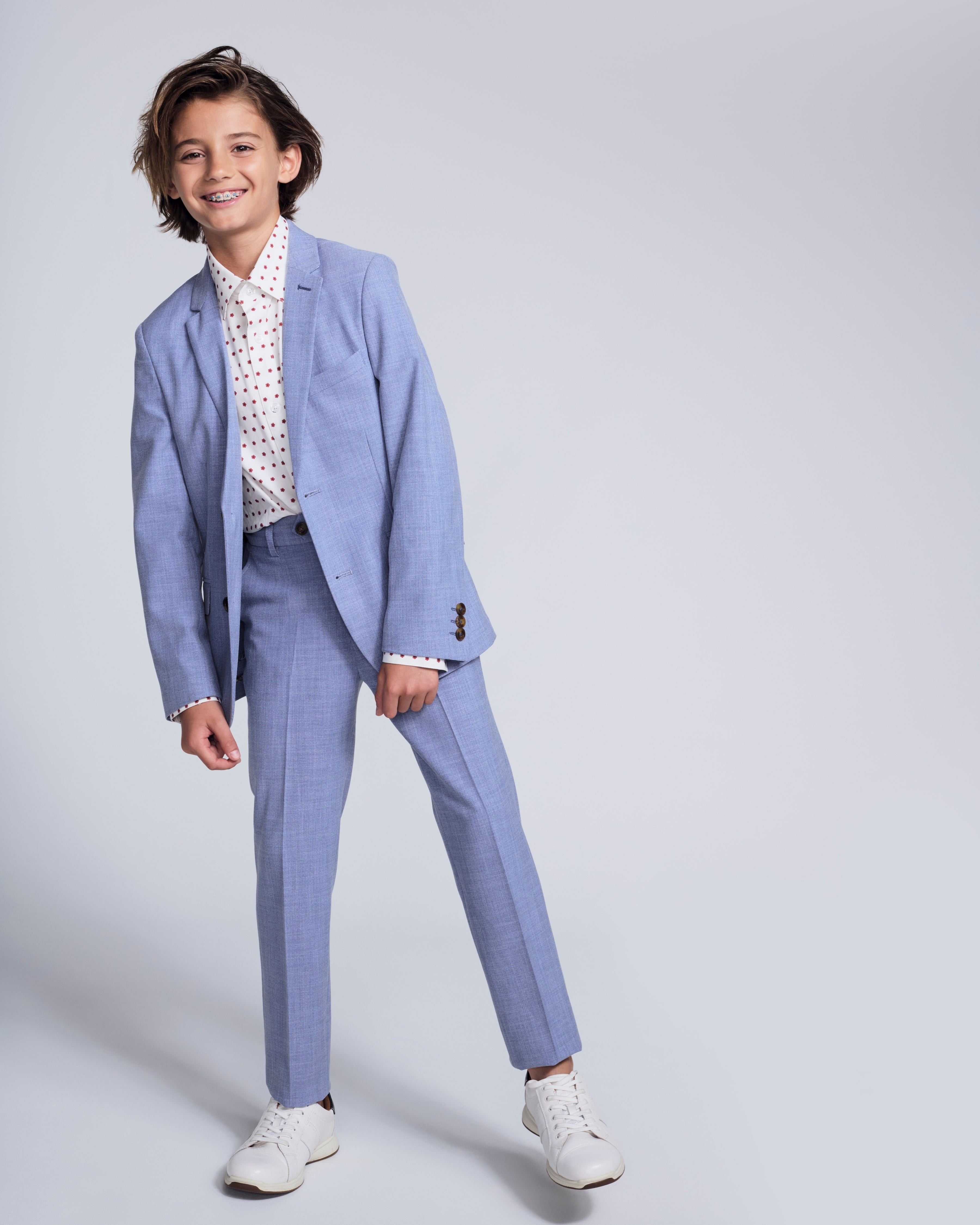 Boy modeling the Pacific Blue Stretchy Mod Suit Pant with a matching blazer and stylish sneakers.