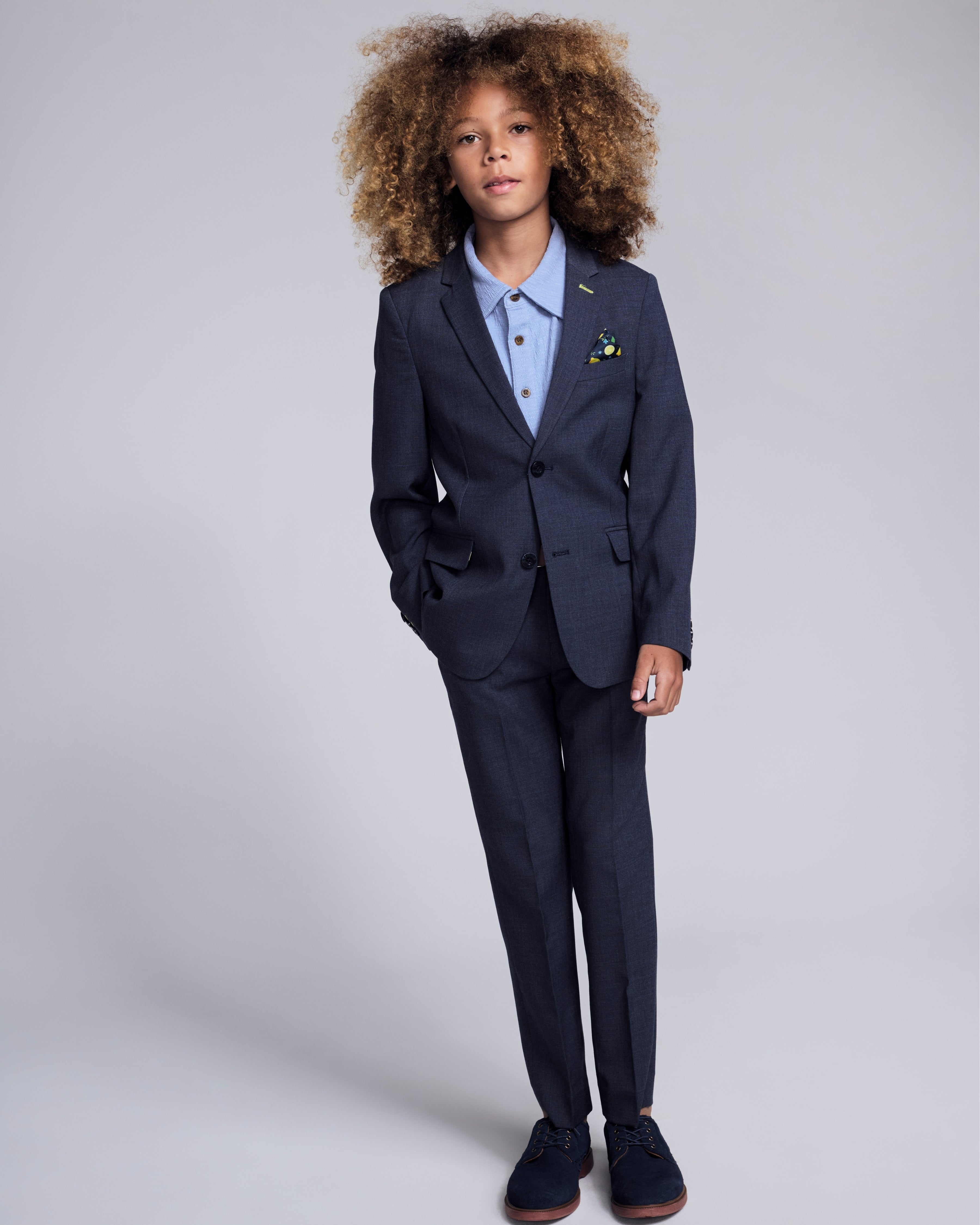 Peacoat Stretchy Mod Suit Pant modeled by a child in a stylish suit with curly hair.