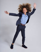 Child wearing Peacoat Stretchy Mod Suit Pant with a blazer, showcasing comfort and style in a playful pose.