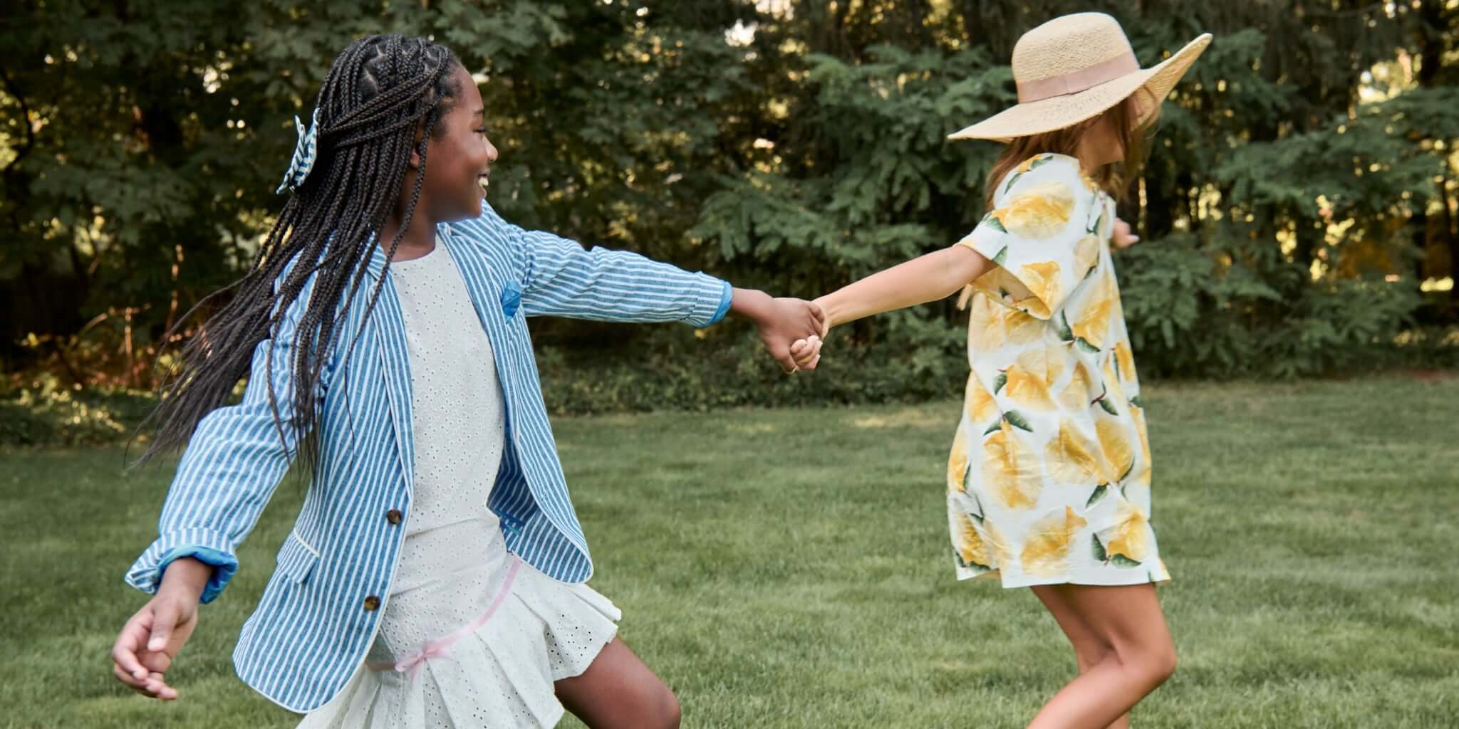 Two people holding hands in a grassy outdoor setting