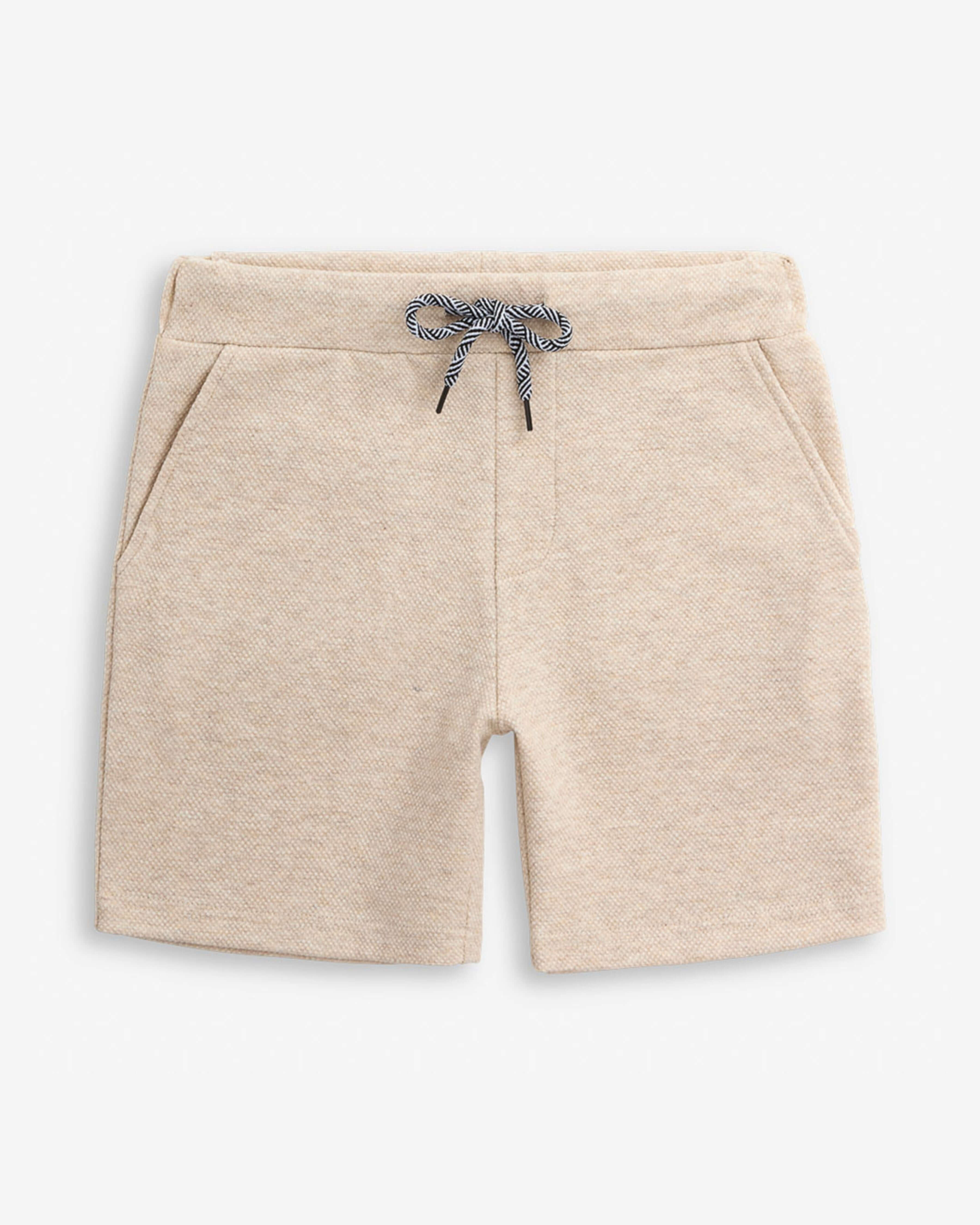 Sandshell Resort Short in beige with functional drawstring and front pockets for kids.