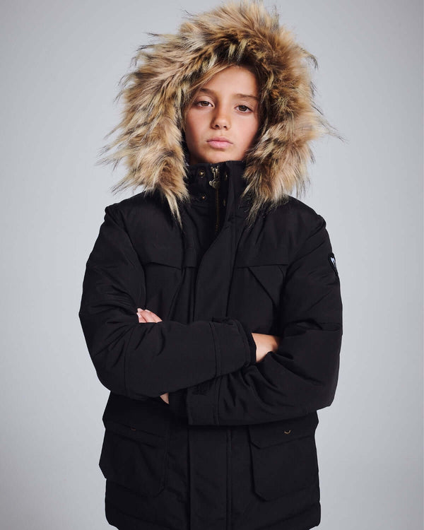 Black Denali Down Coat model wearing a stylish winter jacket with fur-lined hood, perfect for cold weather.