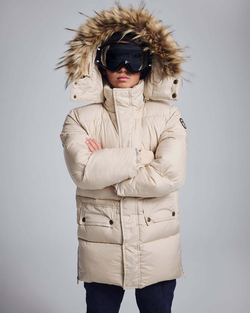 a person wearing a coat with a fur hood and goggles