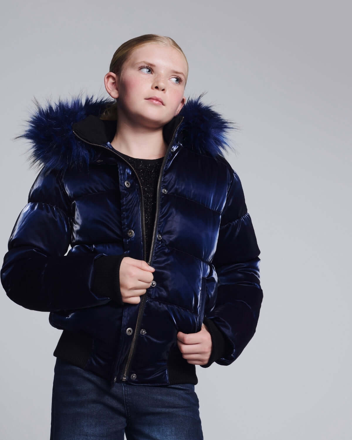 a girl in a blue jacket