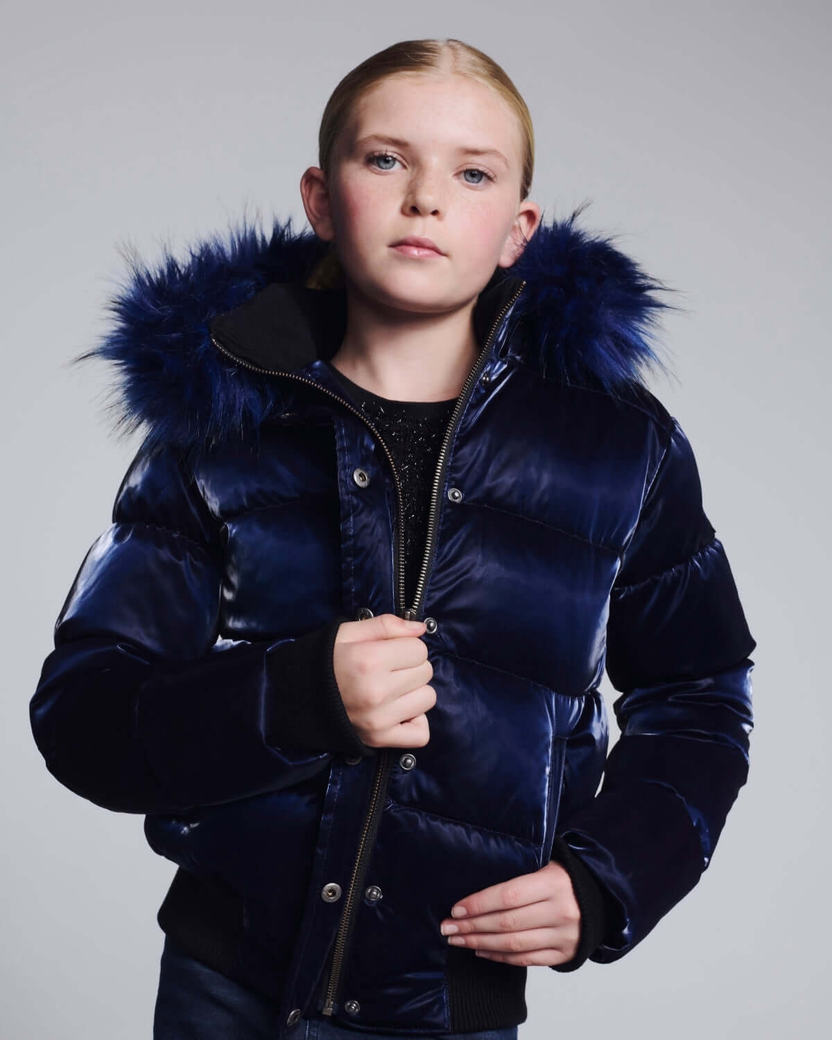 a girl in a blue coat