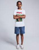 A child wearing a white 'PAWS' graphic t-shirt and Waterfall Preston Short, styled with sneakers.