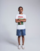 Child wearing Waterfall Preston Short and Paws t-shirt, posing against a neutral background.