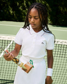 Young girl holding a tennis racket on a tennis court