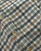 Close-up of the fabric pattern of the Beige Check Glen Flannel Hoodie featuring a check design.