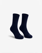 A pair of dark navy crew socks displayed on invisible forms against a clean, light gray background.