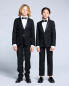 Tuxedo Suit Bundle 3-Piece Set showcased by two children in matching tuxedos, including bow ties and formal dress shirts.