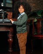 British Khaki Club Pants worn by a stylish boy at a vintage desk, showcasing elegance and comfort.