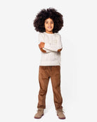 British Khaki Club Pants model wearing a stylish outfit with a cable-knit sweater and corduroy slacks.