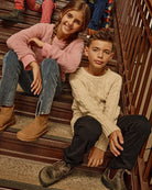 Children wearing stylish outfits, including Pewter Club Pants, while sitting on stairs.