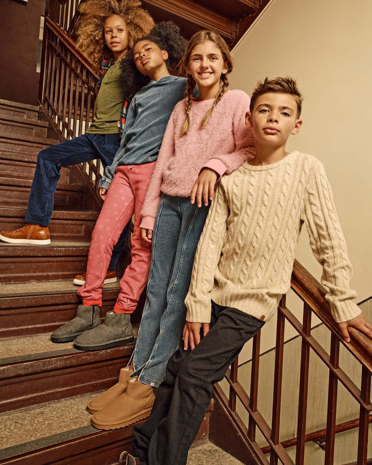Kids wearing stylish outfits including Pewter Club Pants on a staircase.