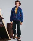 Child wearing Spruce Club Pants paired with a colorful jacket, ideal for adventure and comfort.