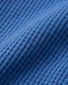 Close-up of textured blue waffle fabric for Classic Blue Craftsman Thermal Henley.