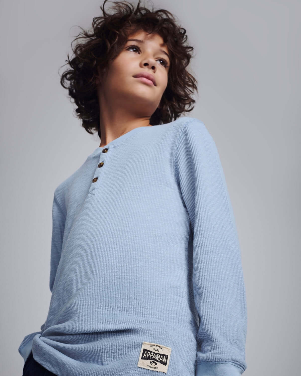 Dusty Blue Craftsman Thermal Henley worn by a child, showcasing its stylish and comfortable design.