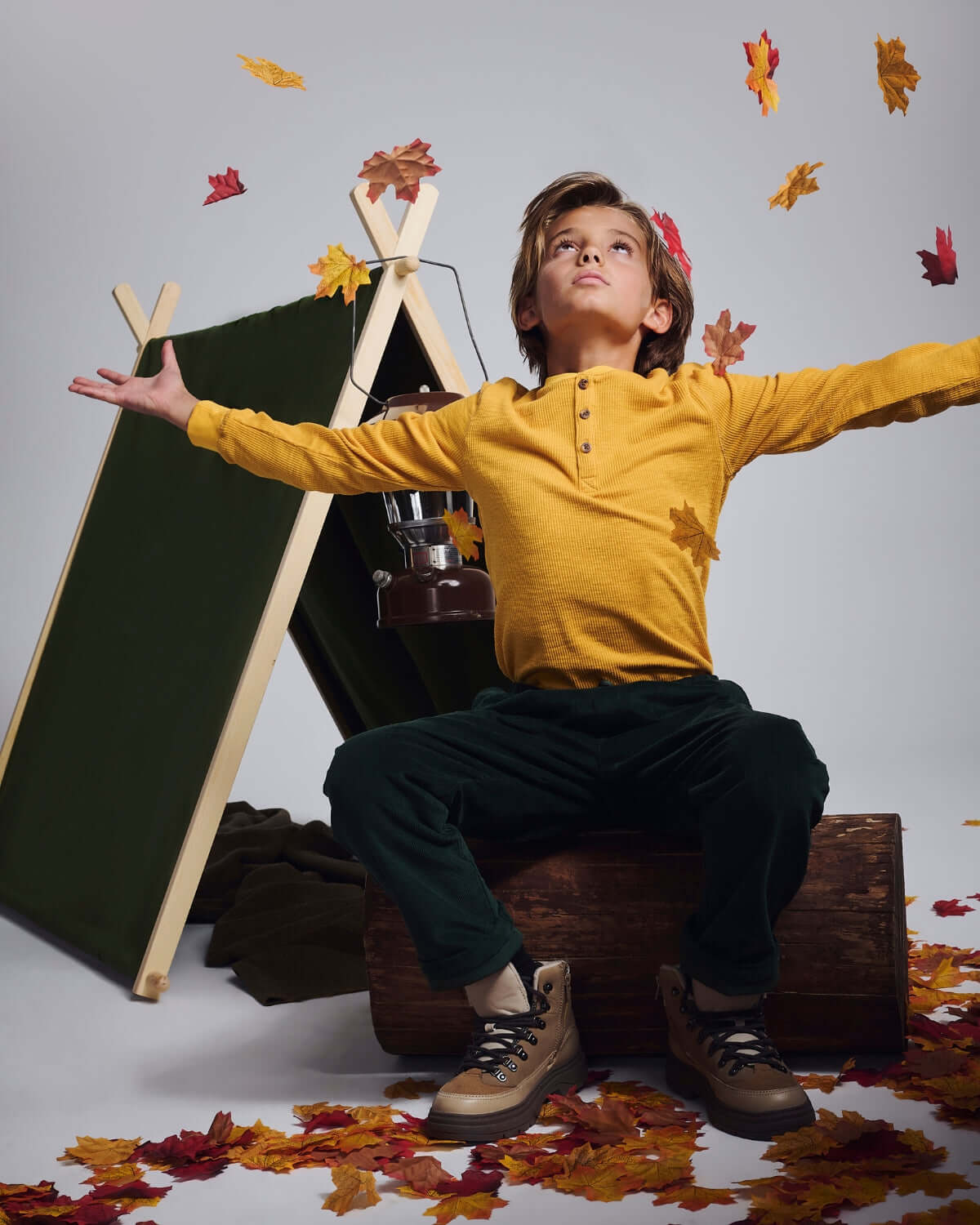 Mustard Craftsman Thermal Henley worn by a boy surrounded by autumn leaves, styled for outdoor adventures.