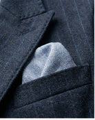 Navy Pinstripe Double Breasted Jacket with blue pocket square in the breast pocket.