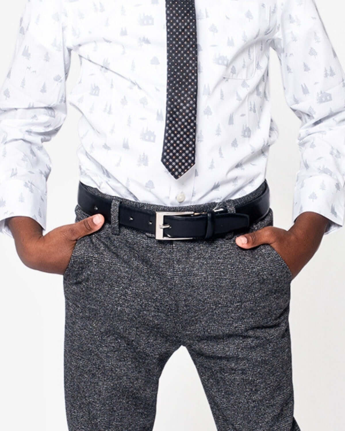 Boy wearing a stylish outfit with a Black Dress Belt and patterned tie, showcasing trendy fashion for kids.