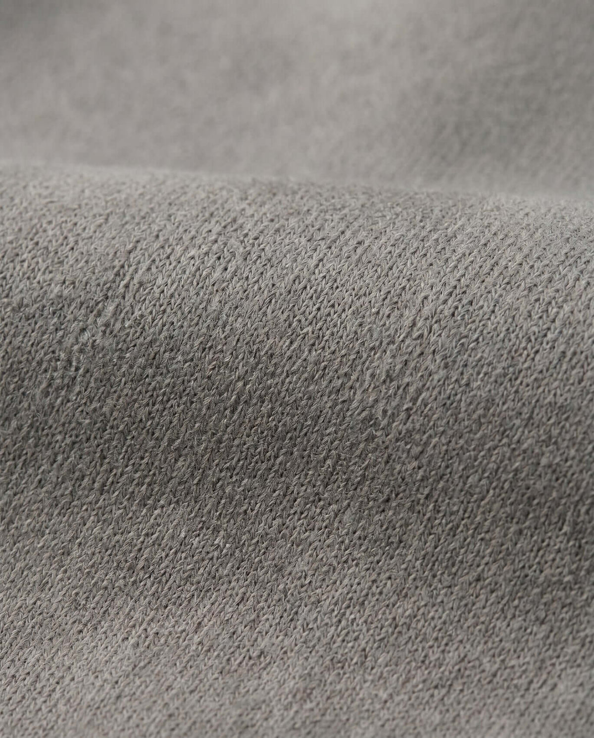 Close-up of the soft fabric used in Cement Empire Sweatpants, showcasing the neutral cement grey texture.