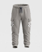 Cement Empire Sweatpants in neutral cement grey with elastic waistband and cargo pockets for active kids.