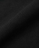 Close-up of the fabric texture used in Black Herringbone Everyday Stretch Dress Pants, showcasing its durable and versatile nature.