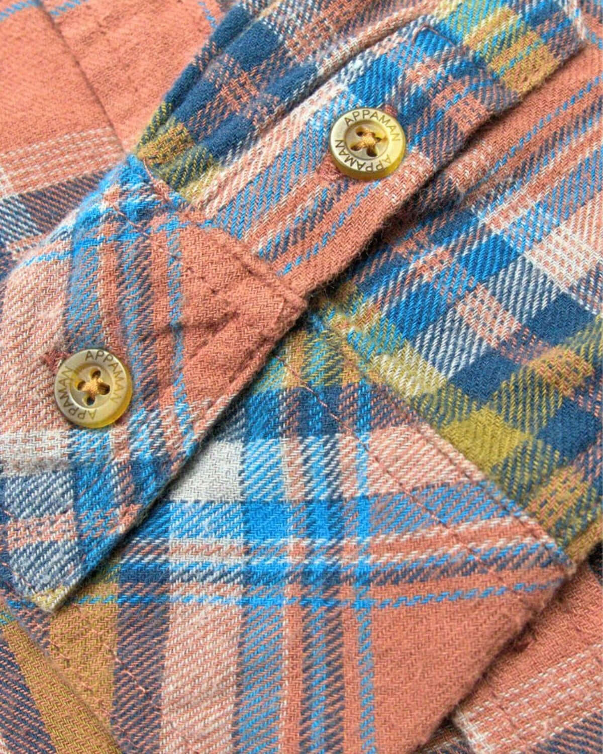 Close-up of the Clay/Jewel Plaid Flannel Shirt showing vibrant plaid pattern and buttons.