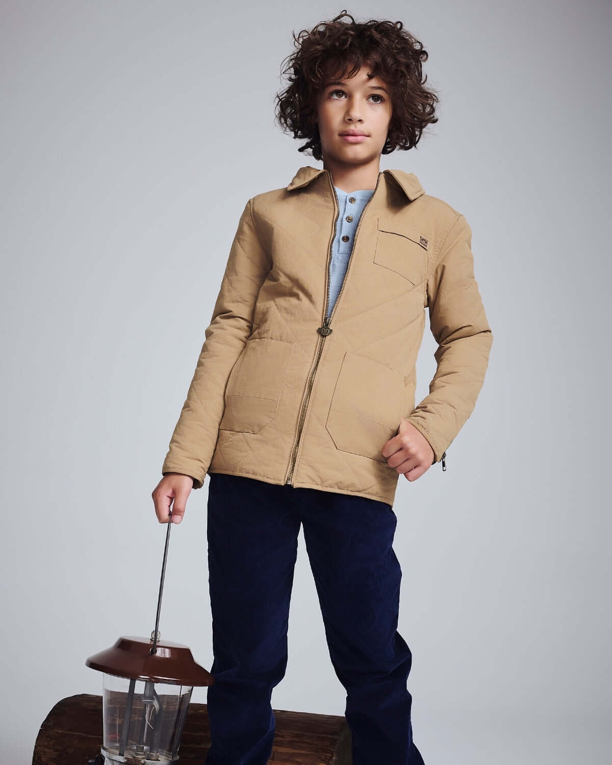 Child wearing a Khaki Flight Jacket, styled with a classic collar and pockets, perfect for adventures.