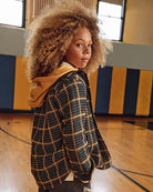 Evergreen Check Glen Flannel Hoodie in a stylish indoor basketball court setting.