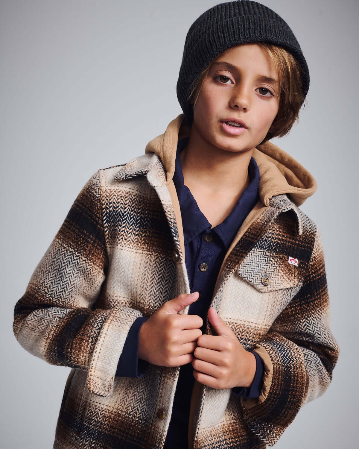 Lumber Plaid Glen Flannel Hoodie worn by a child, featuring a cozy hood and stylish plaid design.