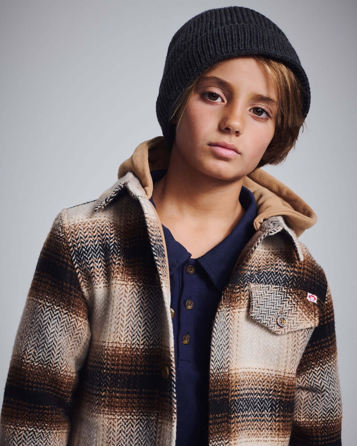 Lumber Plaid Glen Flannel Hoodie on a boy, showcasing stylish plaid design and cozy hood, perfect for adventures.