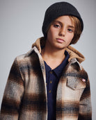Lumber Plaid Glen Flannel Hoodie on a boy, showcasing stylish plaid design and cozy hood, perfect for adventures.