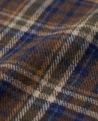 Close-up of Earth Plaid Glen Hooded Shirt fabric showcasing earthy plaid tones and soft texture.