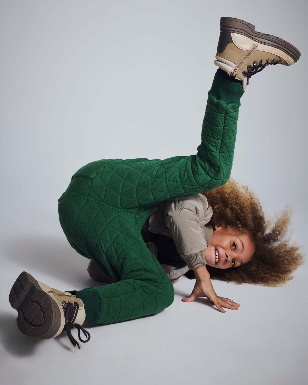 Child wearing Forest Green Highland Sweatpants, showcasing cozy comfort and playful style.
