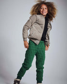 Child wearing Forest Green Highland Sweatpants with a quilted jacket, showcasing stylish and cozy outdoor attire.