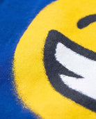 Close-up of the 'Keep Smiling Graphic Long Sleeve Tee' with a bold smiley face on royal blue fabric.