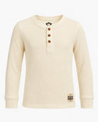 An off-white ribbed long-sleeve henley shirt with three brown buttons, featuring a small monkey logo on the neck and a brand patch on the bottom hem, shown against a plain white background.