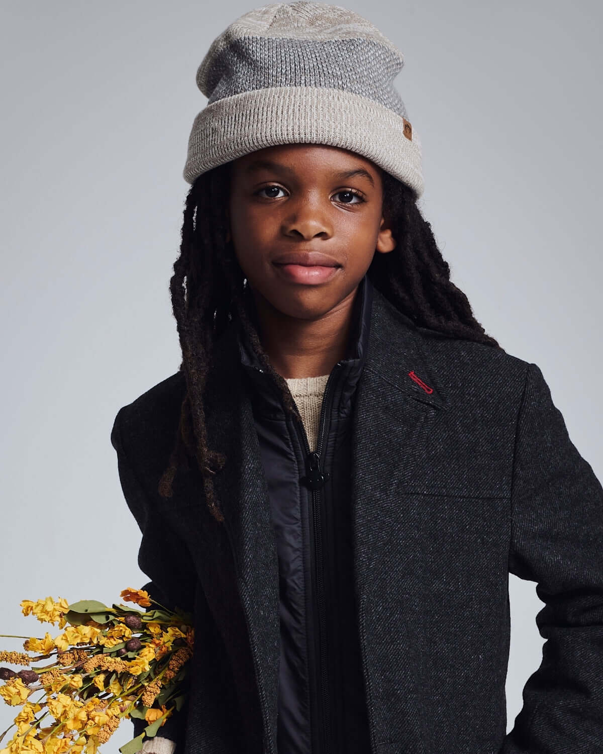 Child wearing a stylish Heather Oatmeal Levi Hat, showcasing comfort and versatility for every adventure.