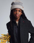 Child wearing a stylish Heather Oatmeal Levi Hat, showcasing comfort and versatility for every adventure.