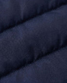 Close-up of the fabric texture of the Dark Navy Packable Lightweight Puffer jacket featuring quilted insulation.