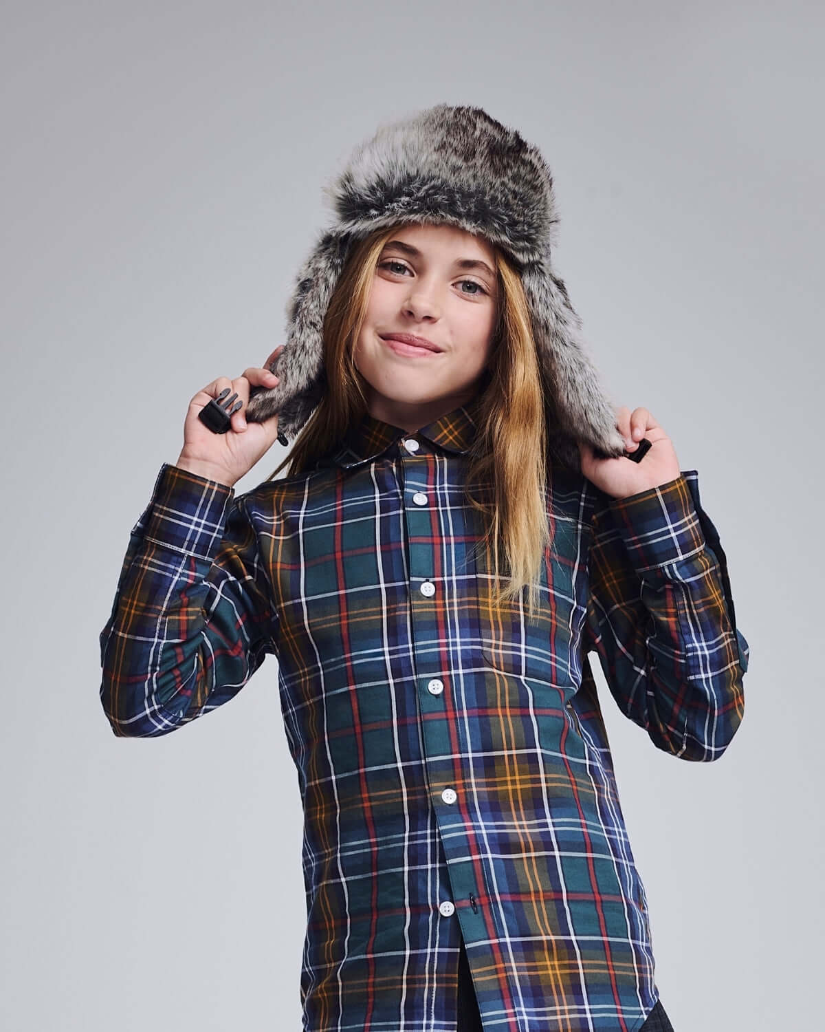 A model wearing a Light Grey Muscle Trapper hat with a plaid shirt, showcasing cozy style and warmth.